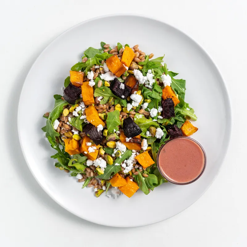 Harvest farro bowl with greens, roasted squash, dates and a pink dressing