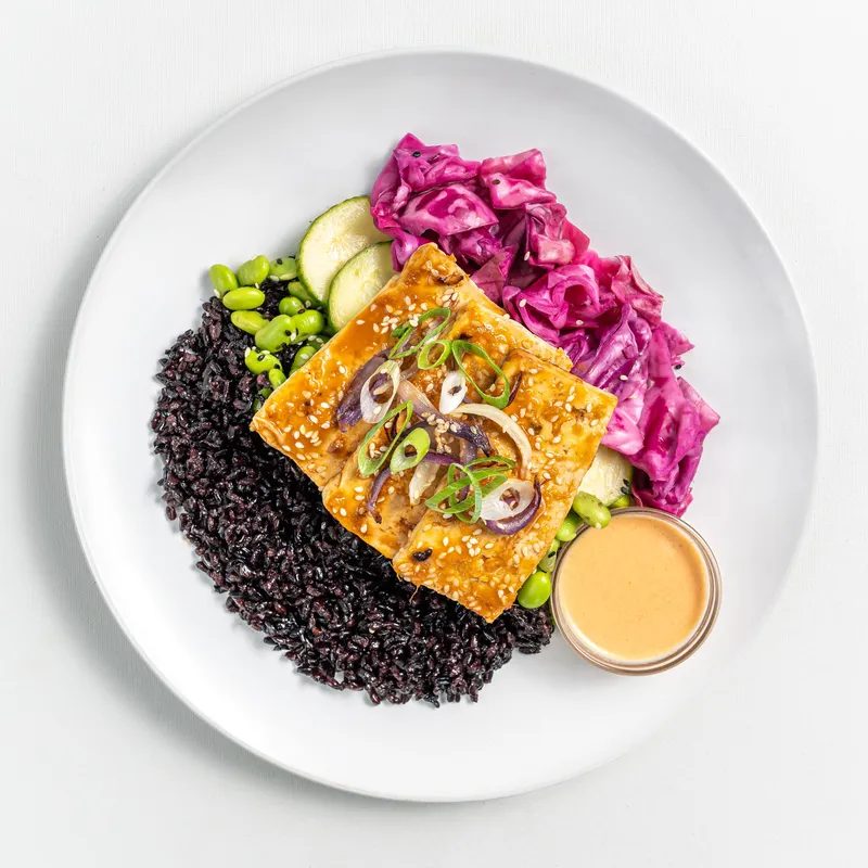 Sesame-ginger tofu poke bowl with black rice, pickled cabbage and edamame