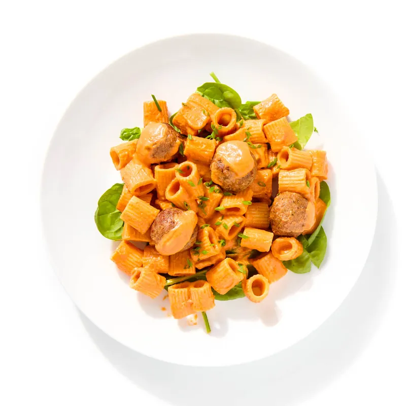 Vegan pasta alla vodka with plant-based meatballs and spinach