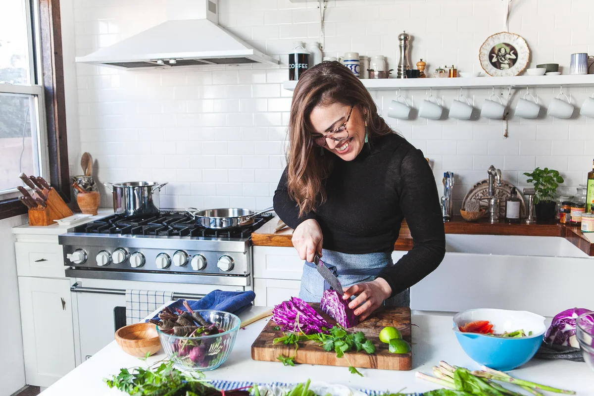 Emily chopping red cabbage in a bright kitchen